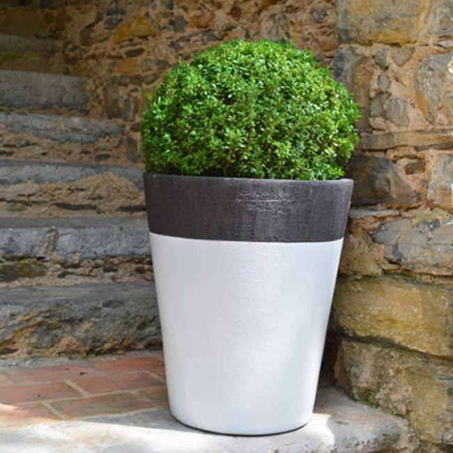 Large Dark Grey Contemporary Mazagran French Pot With A Natural Matt Finish And White Glazed Skirt With A Plant At The Bottom Of Stone Steps from Anduze France