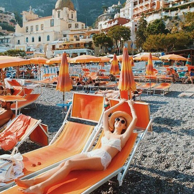 Italian sun lounger - traditional Italian made lettini in orange on an Italian beach