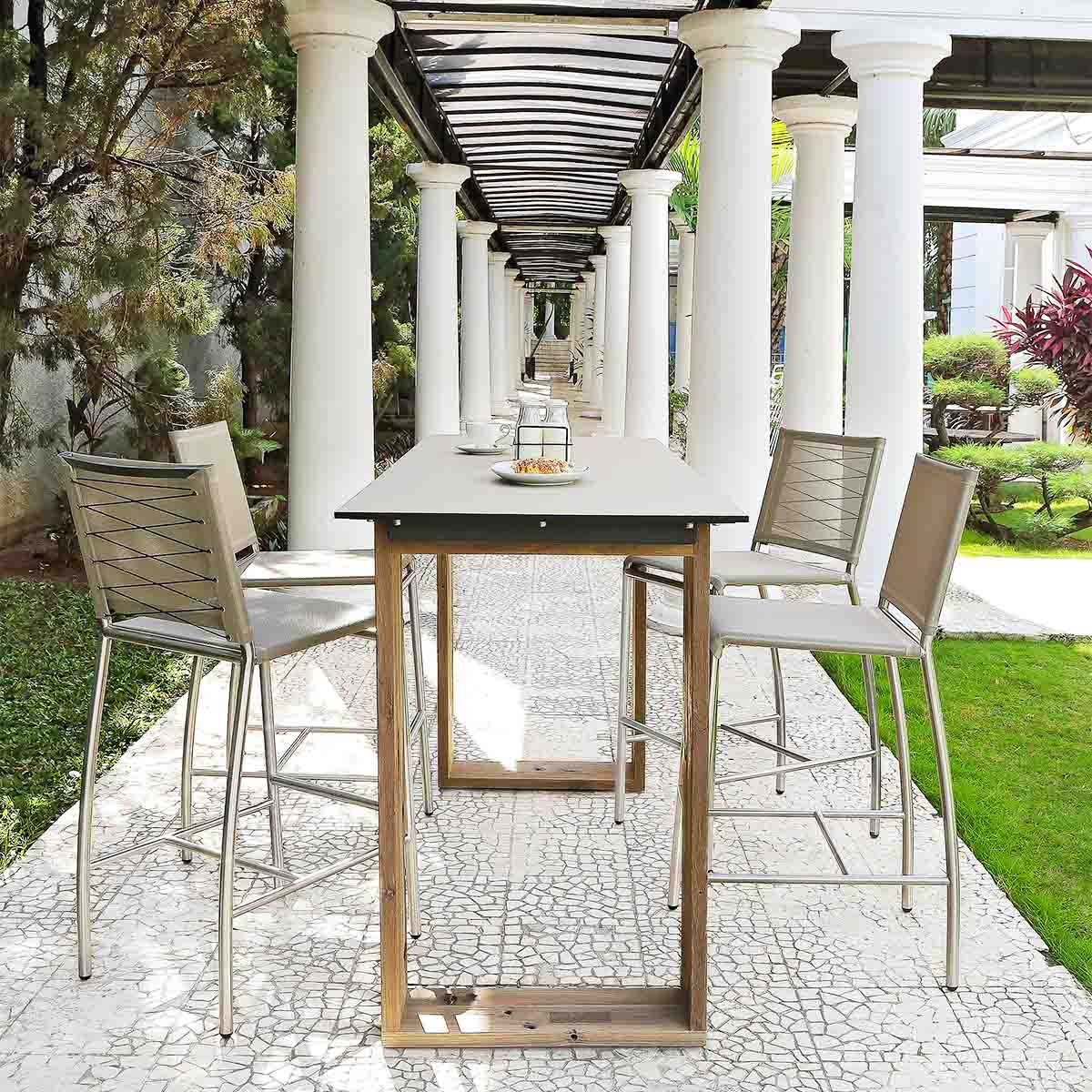 commercial outdoor bar table in a long columned garden courtyard