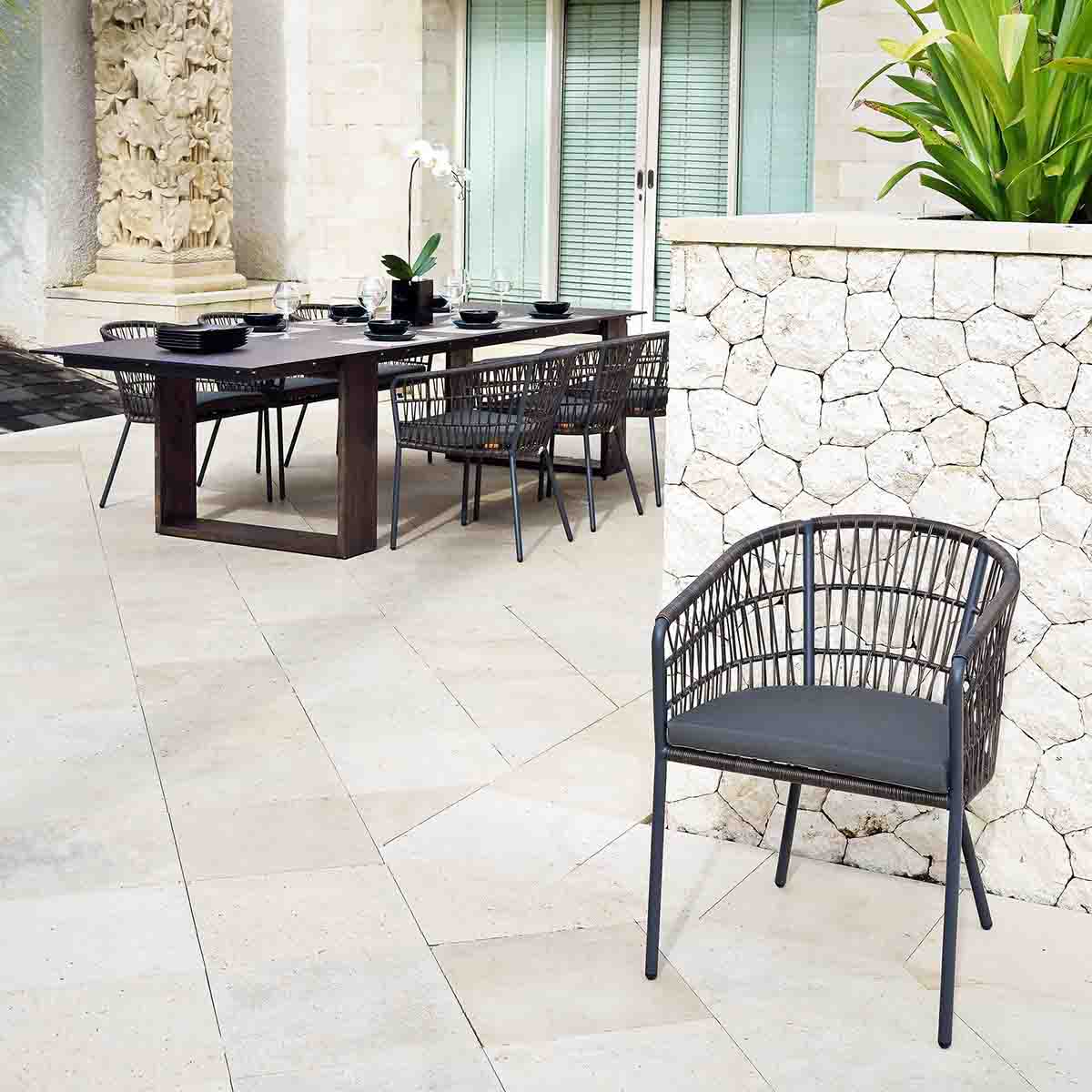 commercial outdoor dining chairs in a tiled courtyard