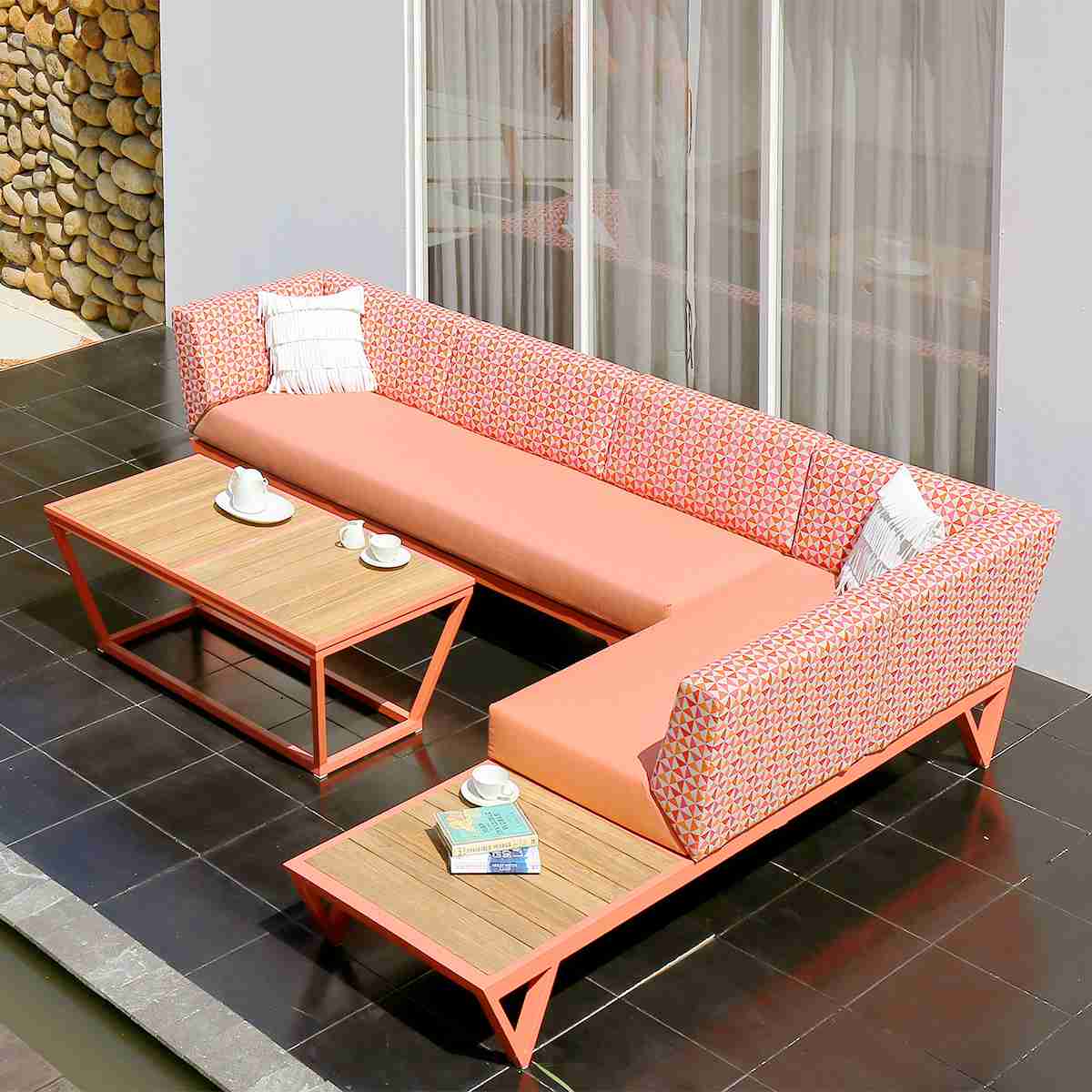 commercial outdoor lounge setting in red and orange patterned fabric with coffee table
